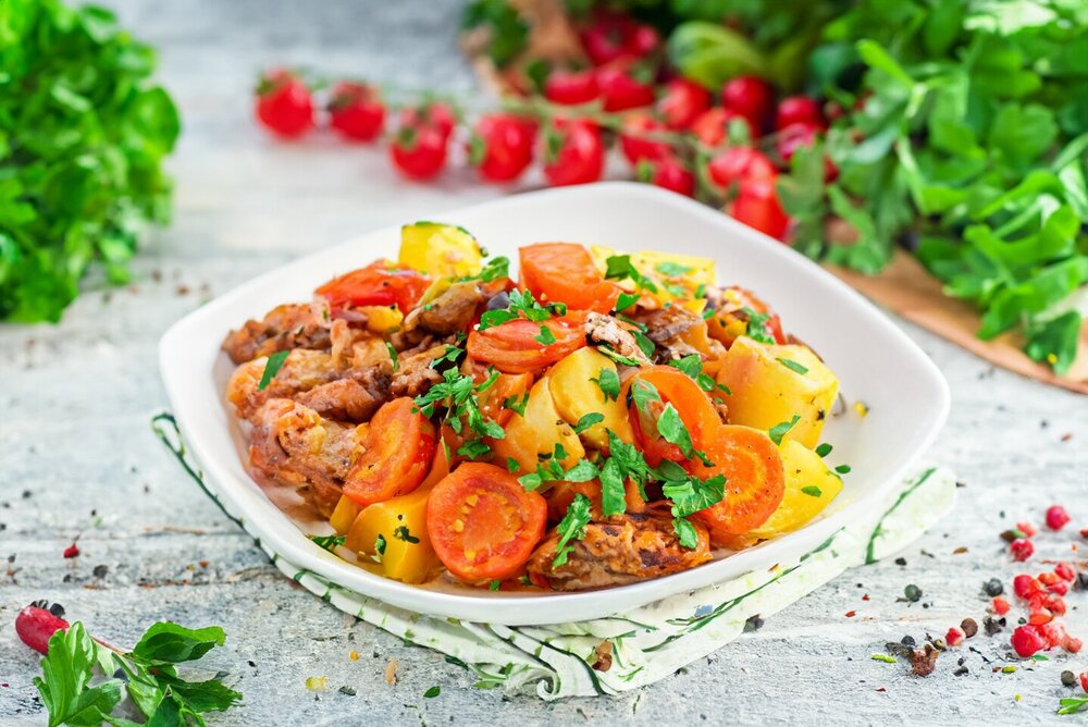 Meat with Potatoes on a Baking Sheet in the Oven