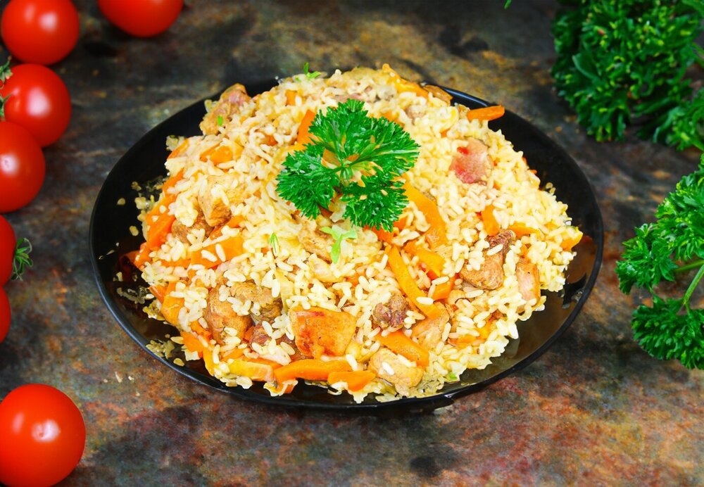 Uzbek Pork Pilaf in a Cauldron on the Stove