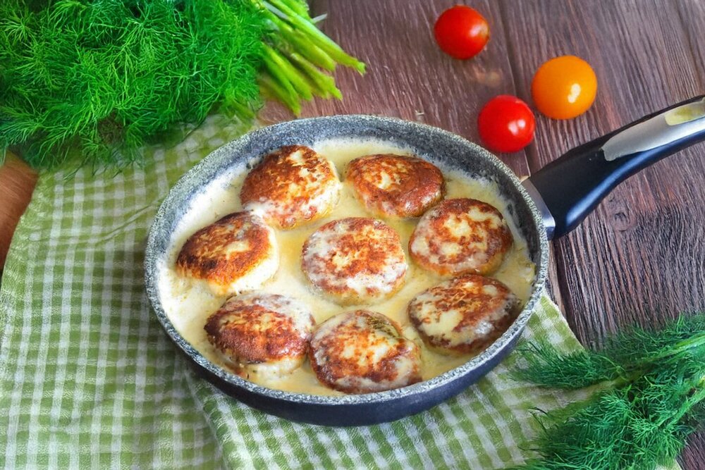 Chicken patties in a creamy sauce in a pan